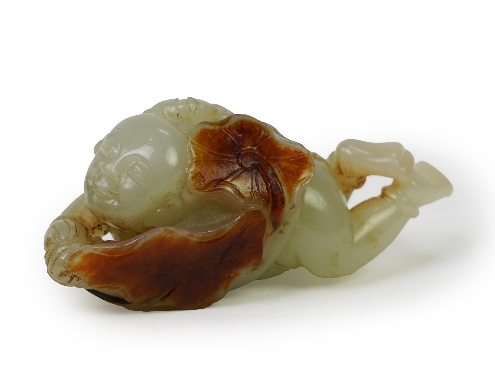A Chinese pale celadon and russet skin jade figure of a boy and lotus